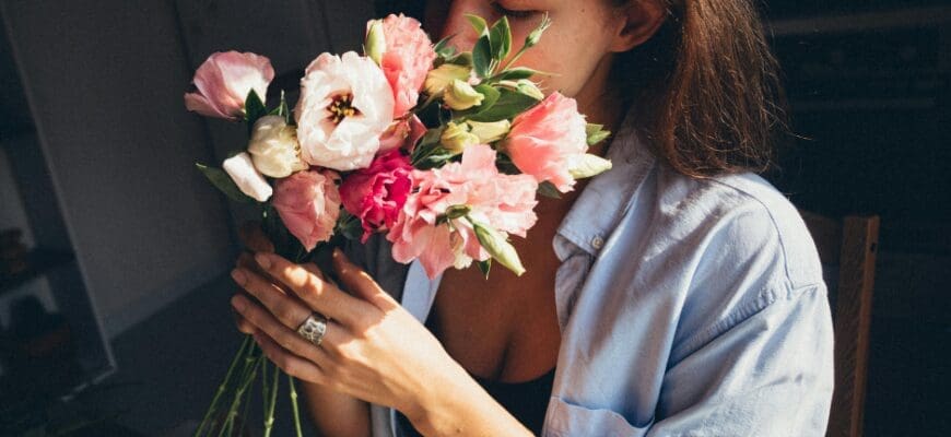 Woman Smelling a Bouquet of Flowers